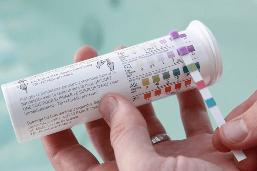 Measuring the hot tub's chlorine concentration using testing strips