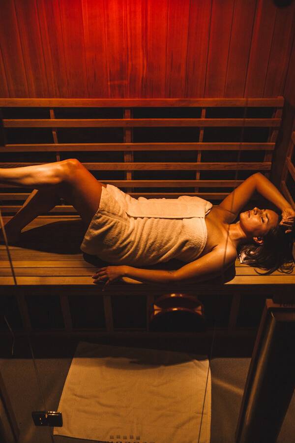 Woman relaxing in an affordable sauna
